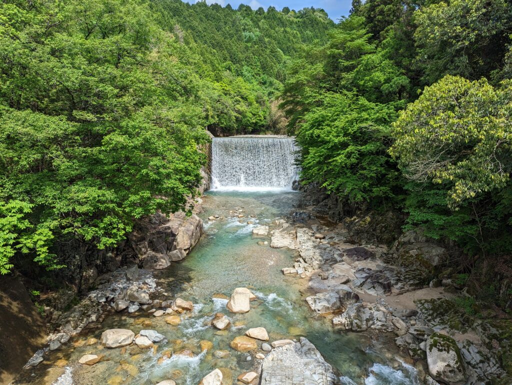 Ein etwas künstlicher Wasserfall inmitten einer grünen Wander-Idylle.